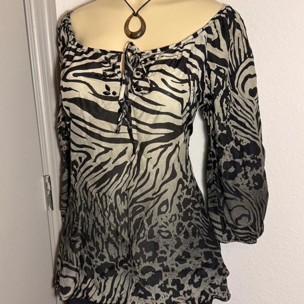 Animal print long sleeve top with tie front and jeweled neckline